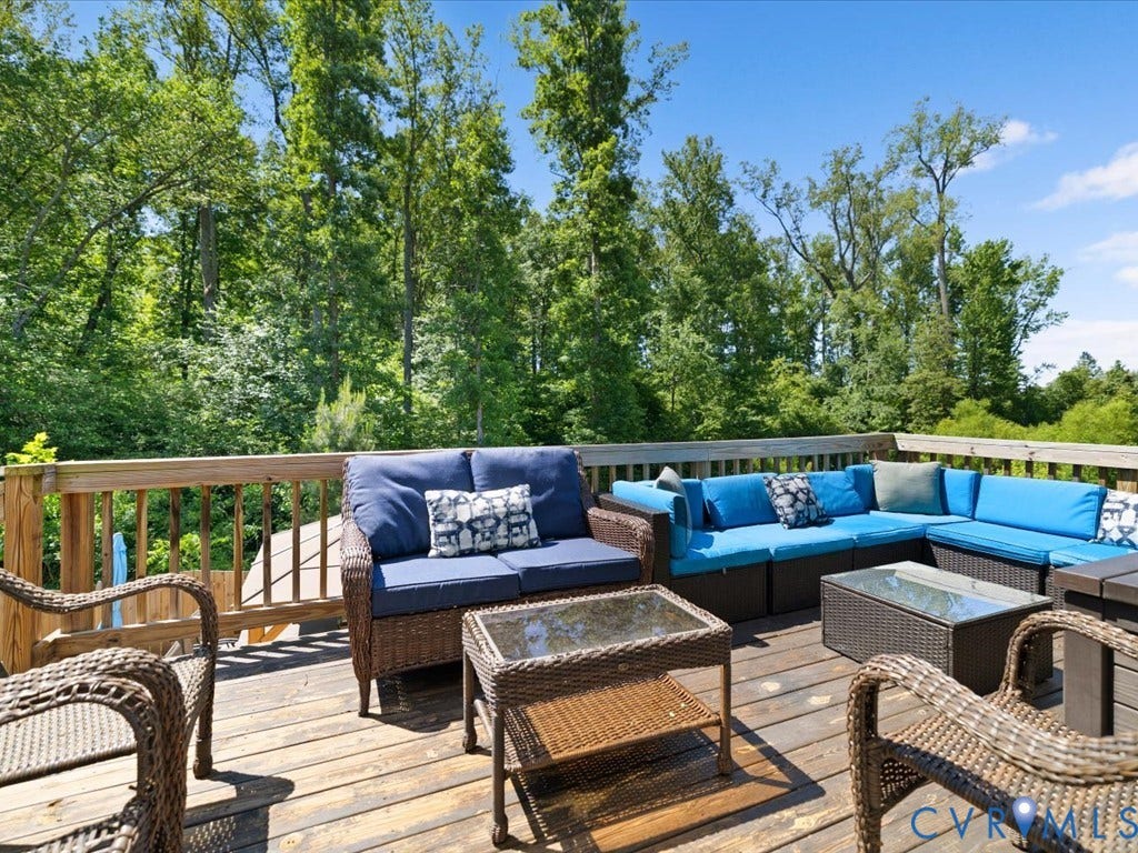 Spacious outdoor deck with a wood-plank surface and wood railing