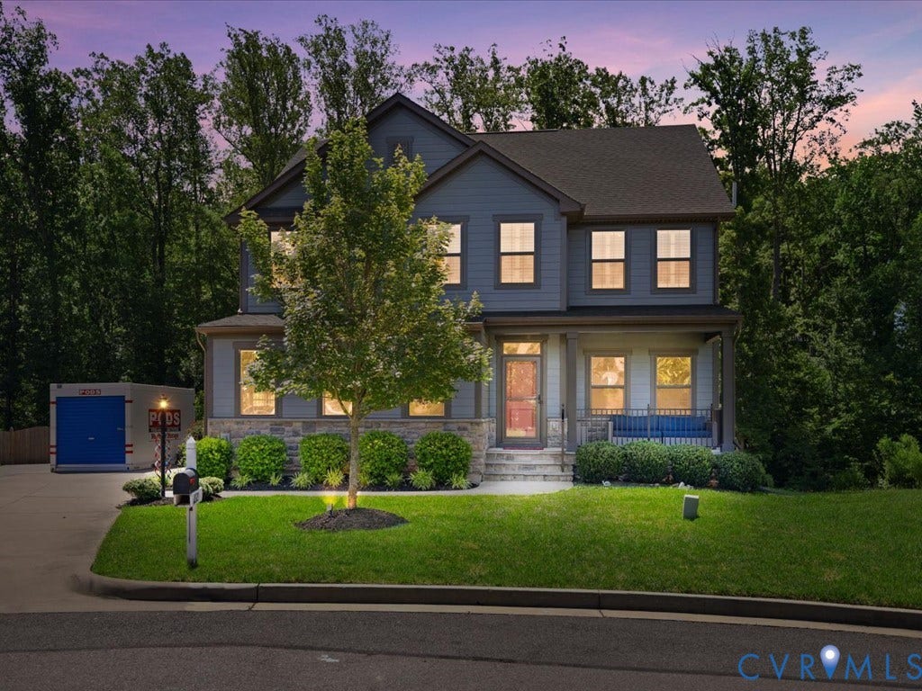 Two-story residence with a covered front porch and stone accenting