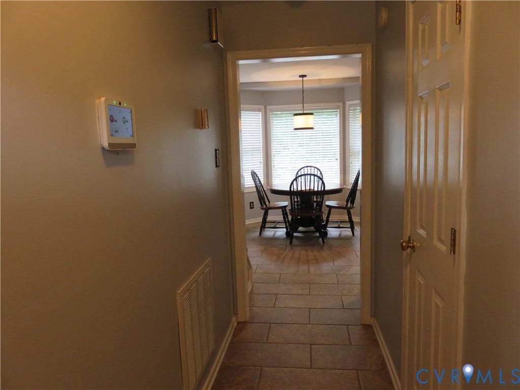 3107 McCabe Court, Chester, VA 23831 Hallway with tile flooring opening to a space with bay windows