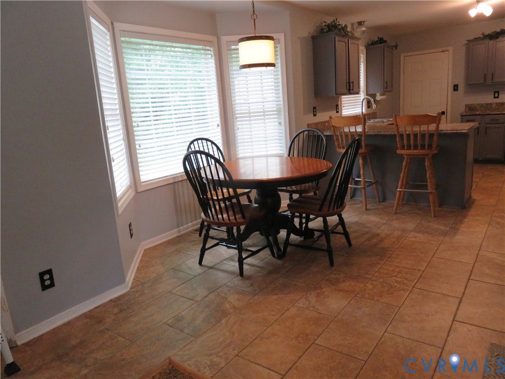 3107 McCabe Court, Chester, VA 23831 Kitchen featuring tile flooring, gray cabinetry, a peninsula with seating, and a bay window