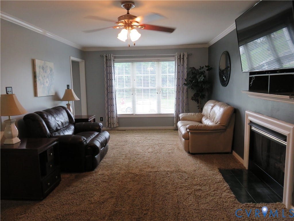 3107 McCabe Court, Chester, VA 23831 Recessed fireplace with hearth, ceiling fan with light kit, crown molding, and a prominent window