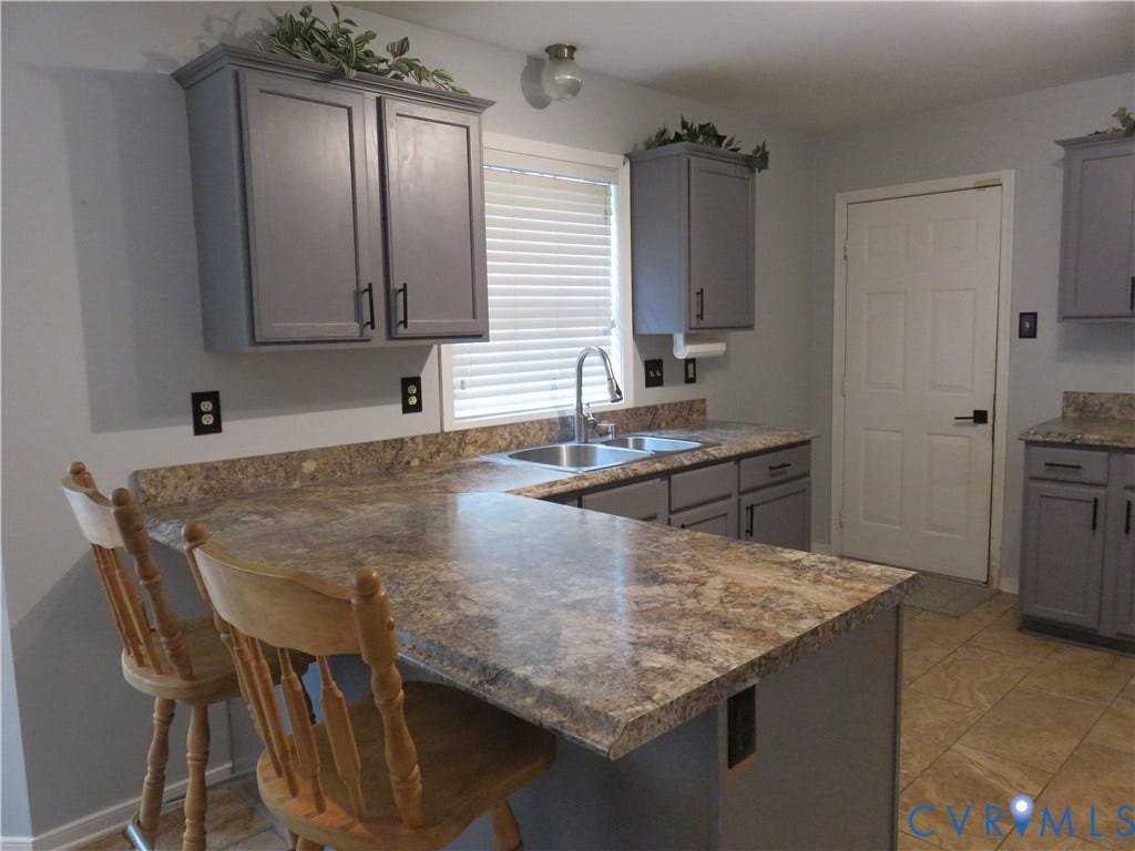 3107 McCabe Court, Chester, VA 23831 Kitchen featuring gray cabinetry, dual basin sink with pull-down faucet, patterned countertops, and tile flooring