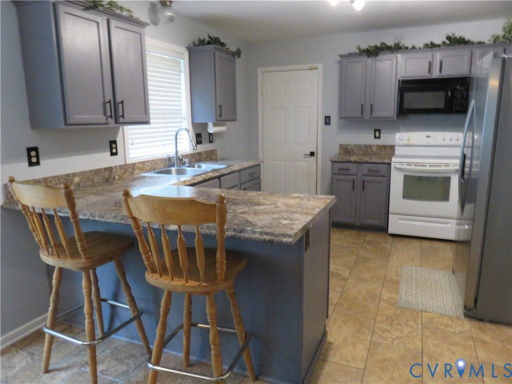 3107 McCabe Court, Chester, VA 23831 Kitchen featuring grey cabinetry, stone-finish countertops, stainless steel sink, tile flooring, and integrated black microwave