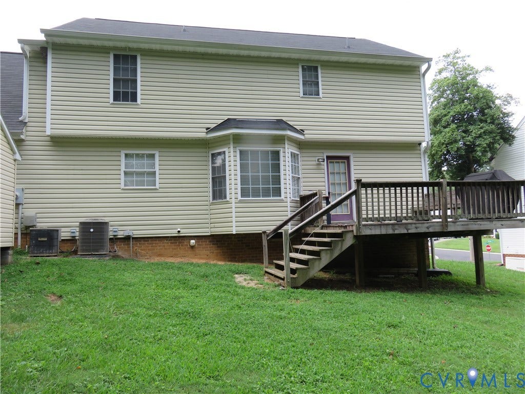 3107 McCabe Court, Chester, VA 23831 Rear exterior with light-colored siding, a multi-pane bay window, and an elevated wood deck with stairs