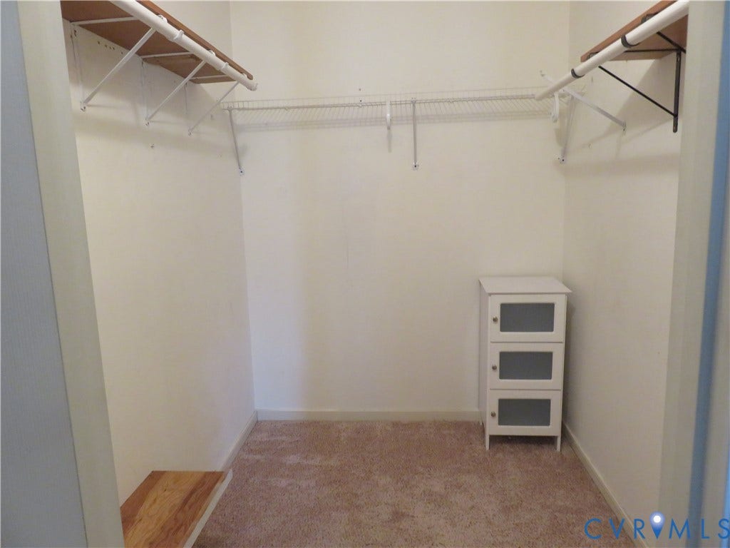 3107 McCabe Court, Chester, VA 23831 Carpeted closet with wire shelving system and wood-finish upper shelves