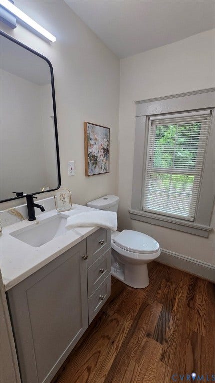 2317 5th Avenue, Richmond, VA 23222 Light-colored vanity with built-in sink, dark bronze faucet, and wood-finish flooring