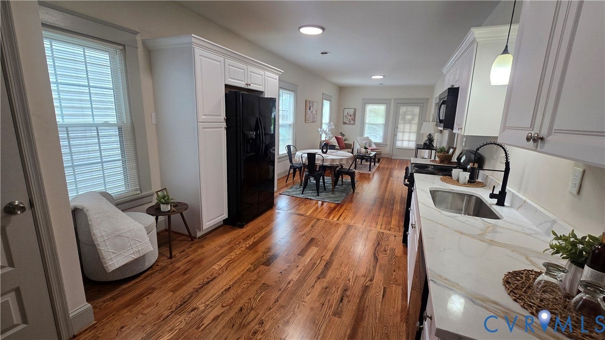 2317 5th Avenue, Richmond, VA 23222 Hardwood-finish flooring, white cabinetry, black stainless steel appliances, stone-finish countertops, and a stainless steel sink with a matte black faucet