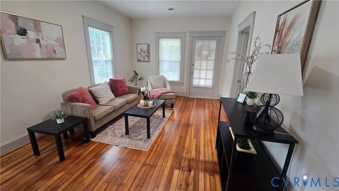 2317 5th Avenue, Richmond, VA 23222 Hardwood flooring throughout, white painted walls, multiple windows with white trim, and a built-in shelving unit