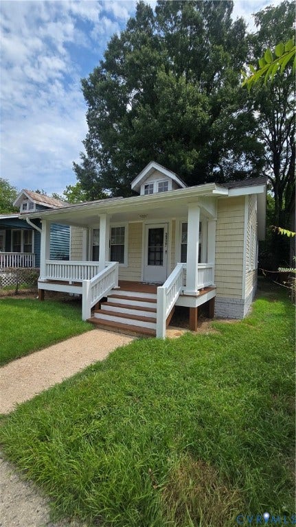 2317 5th Avenue, Richmond, VA 23222 Front exterior with light yellow siding, white trim, and a covered porch