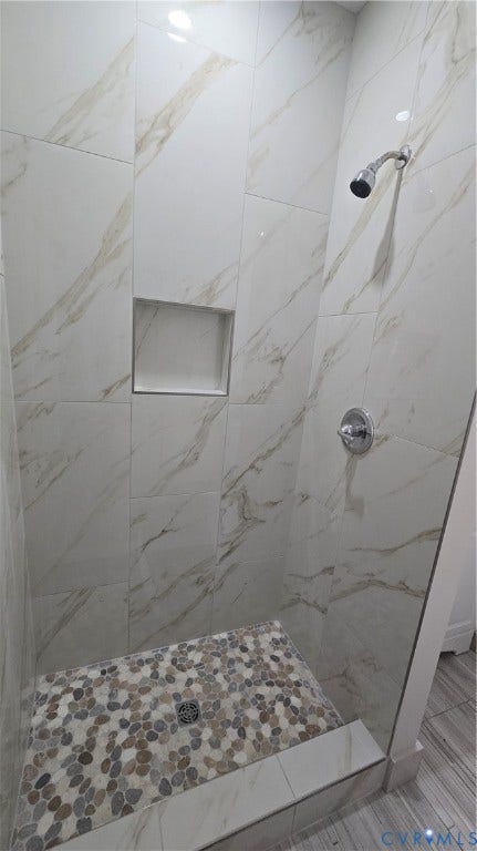 2317 5th Avenue, Richmond, VA 23222 Walk-in shower with large format wall tiles, a built-in shower niche, and a pebble-tiled shower pan