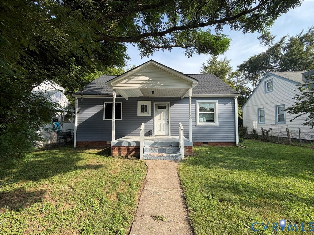 3911 Larchmont Lane, Richmond, VA 23224 Gray siding exterior with white trim, covered porch, and a concrete pathway