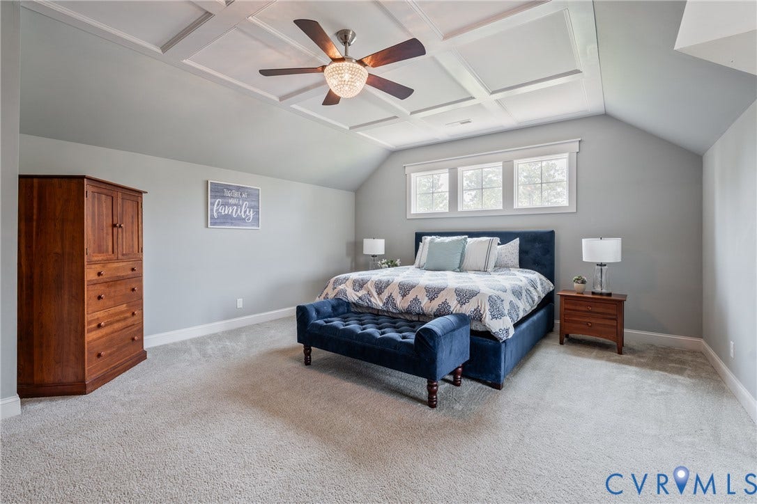 Coffered ceiling with a ceiling fan, triple windows, vaulted ceiling, and light gray wall paint
