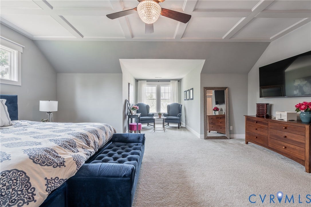 Tray ceiling with a decorative light fixture and ceiling fan