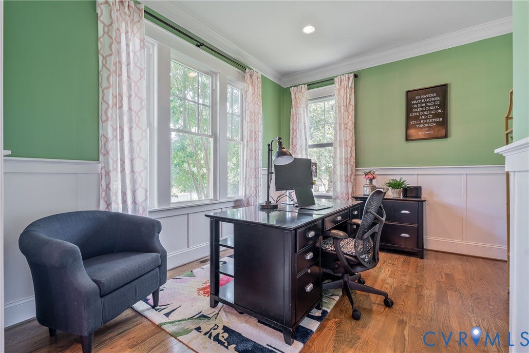Hardwood flooring with extensive paneling and crown molding