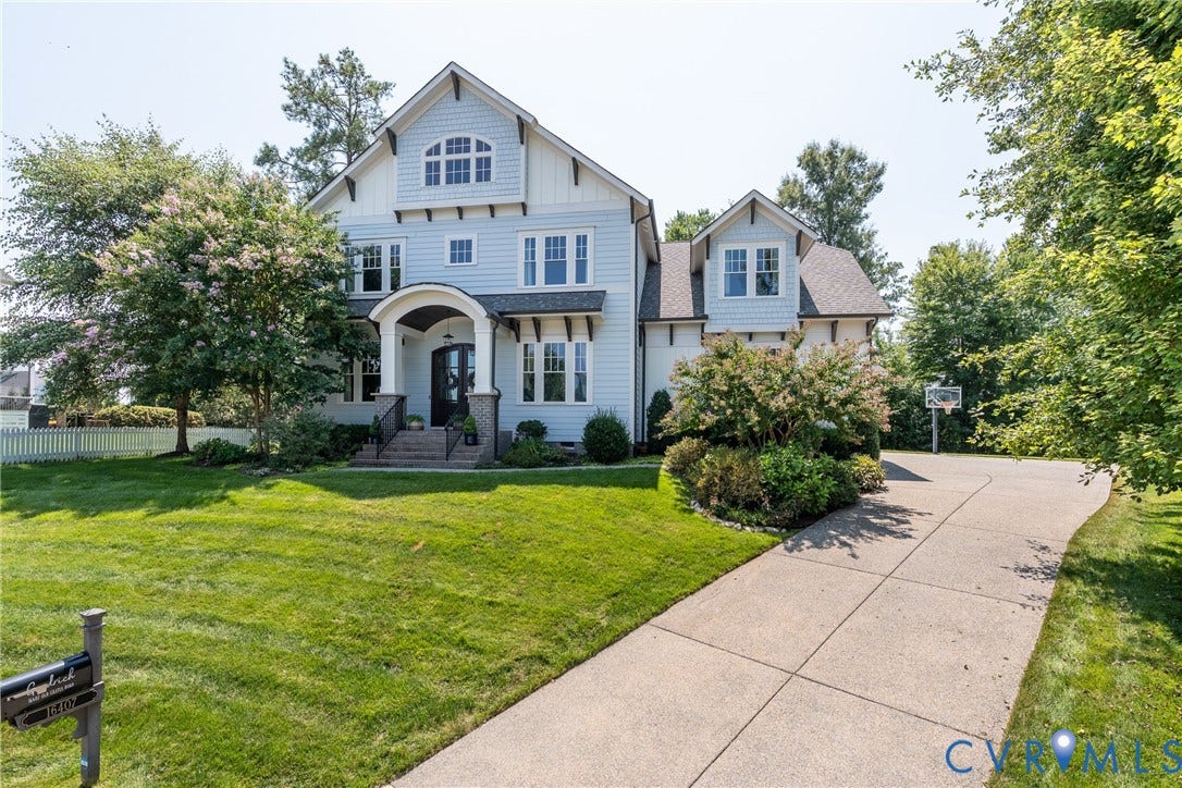 Light blue siding exterior with white trim and shingle accents