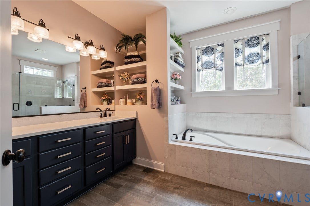 Double vanity with dark cabinetry and light-colored countertop