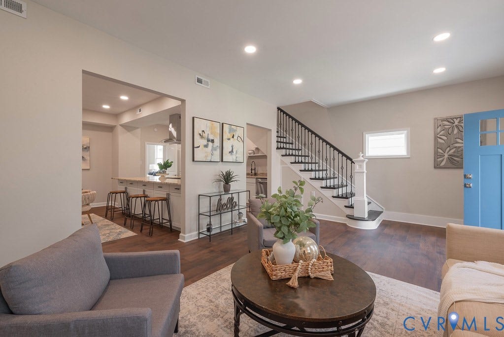 Wood-finish flooring throughout, recessed lighting, and a kitchen featuring an extended peninsula with seating
