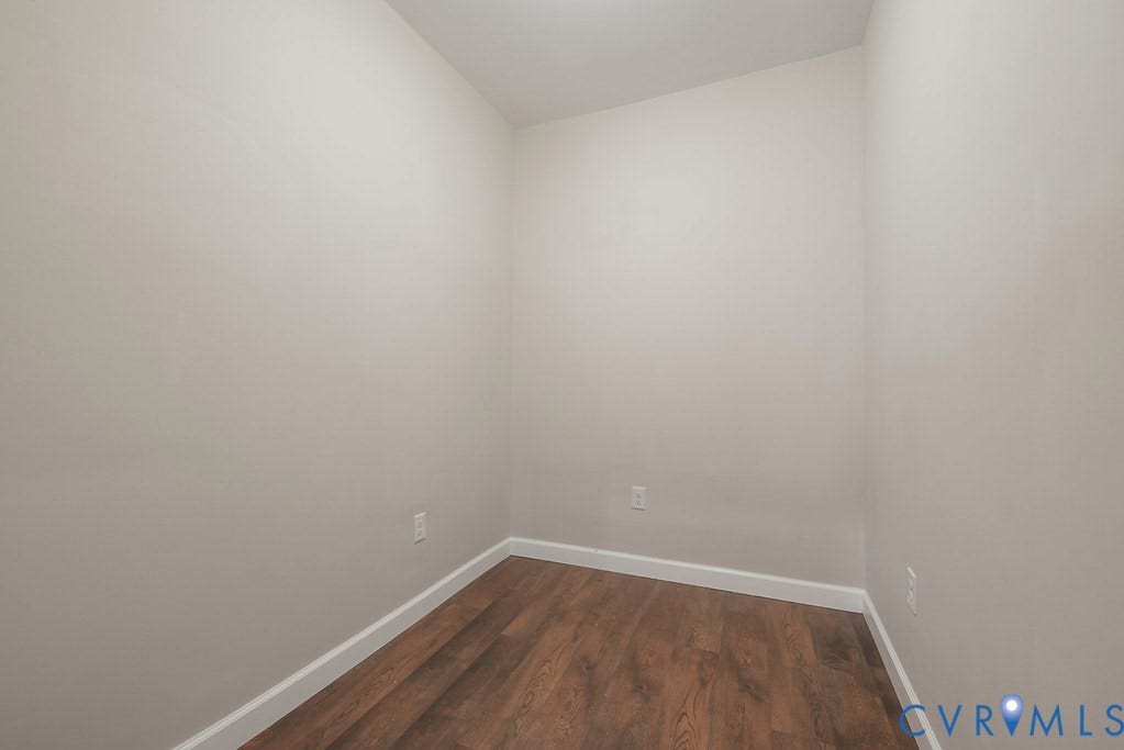Recessed lighting, light neutral wall color, wood-finish flooring, and white trim