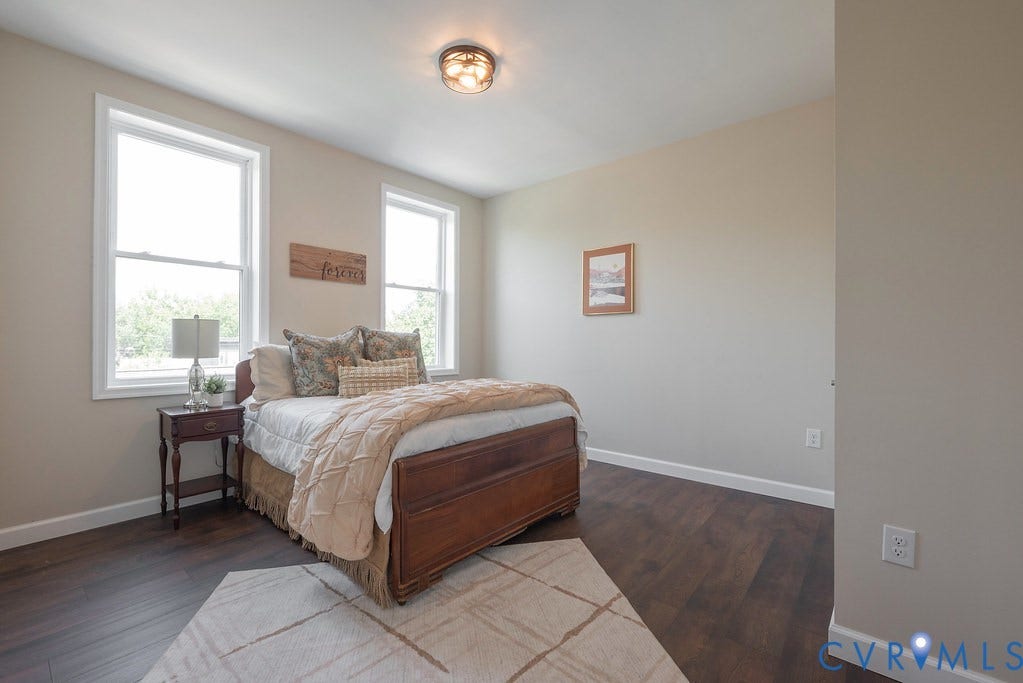 Neutral wall paint, recessed lighting, and wood-finish flooring