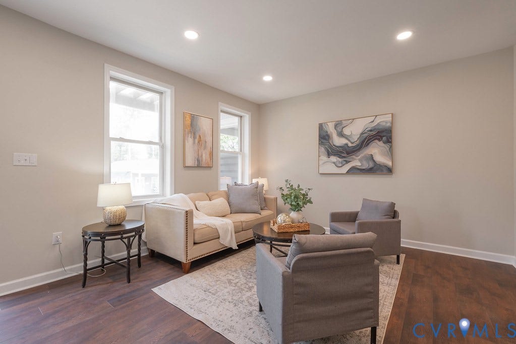 Recessed lighting, wood-finish flooring, light-toned wall paint, and white trim