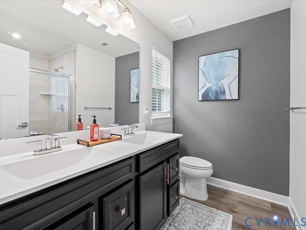 Dual vanity with integrated sinks, framed mirror, and chrome fixtures