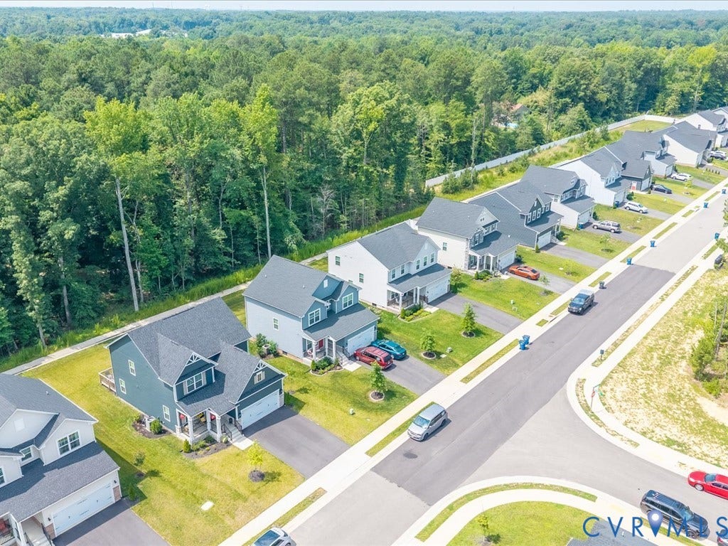 Residential street with uniform sidewalks and manicured lawns