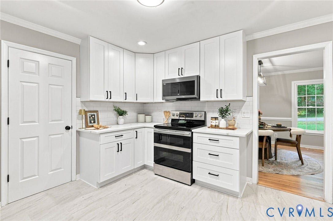 4106 Gloucestershire Street, North Chesterfield, VA 23236 White shaker cabinetry, stainless steel appliances, white subway tile backsplash, light-toned wood-finish flooring, and crown molding