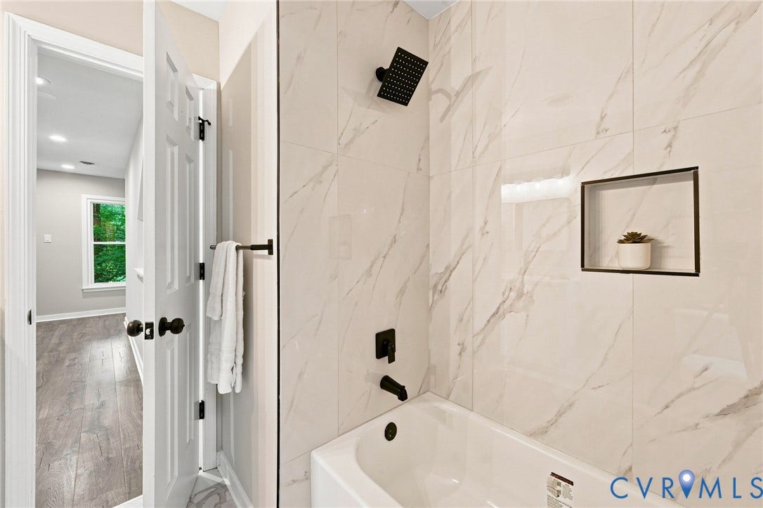 4106 Gloucestershire Street, North Chesterfield, VA 23236 Bathtub with matte black fixtures, white tile surround, and a recessed wall niche
