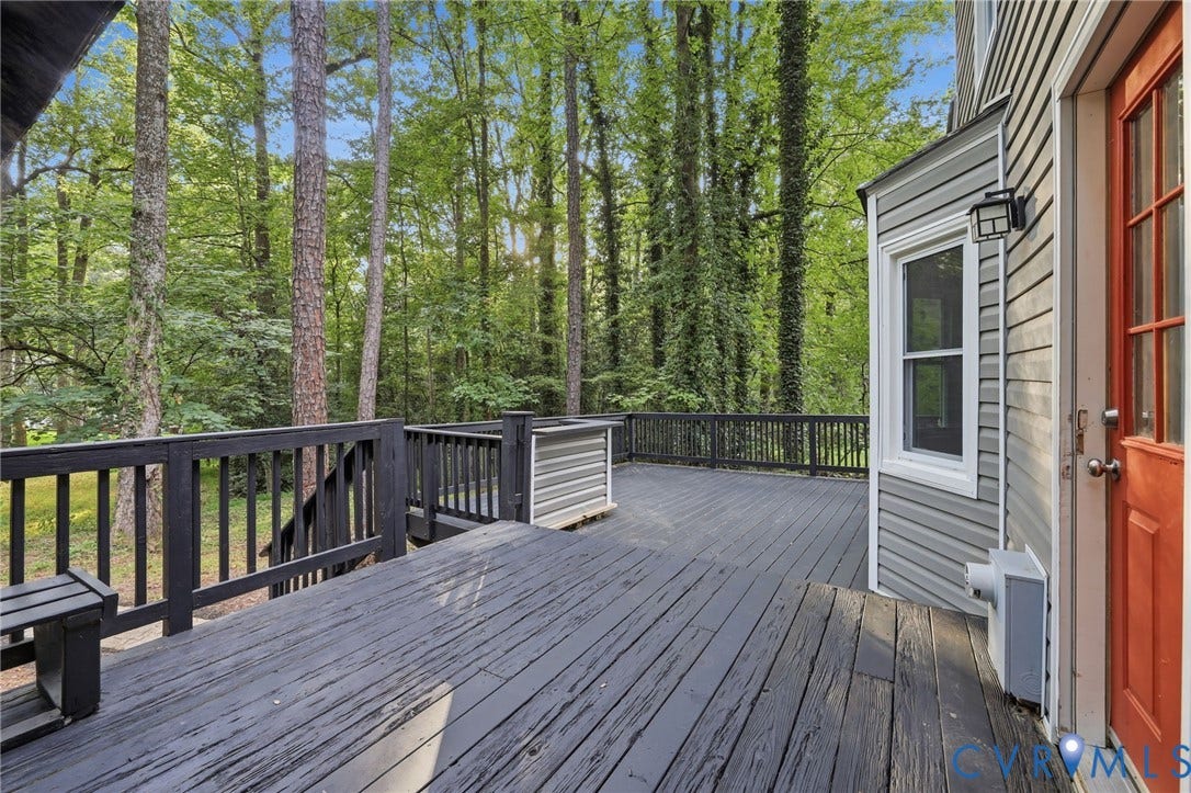 4106 Gloucestershire Street, North Chesterfield, VA 23236 Expansive wood-finish decking with railings and exterior lighting, featuring a side-hinged exterior door