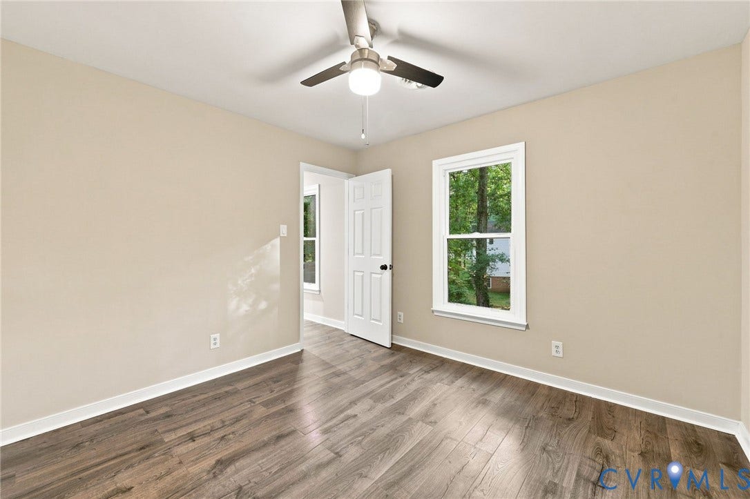 4106 Gloucestershire Street, North Chesterfield, VA 23236 Wood-finish flooring, neutral wall tones, multi-pane windows, and a ceiling fan with integrated lighting