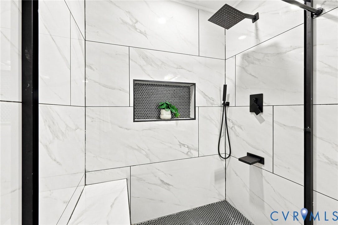 4106 Gloucestershire Street, North Chesterfield, VA 23236 Walk-in shower with black-framed glass enclosure, white tile walls, a built-in shower niche, a built-in bench, and black hexagonal floor tiles