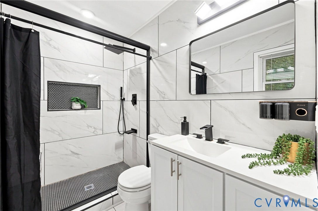 4106 Gloucestershire Street, North Chesterfield, VA 23236 Shower with black-framed glass enclosure, built-in shelving niche, and matte black fixtures