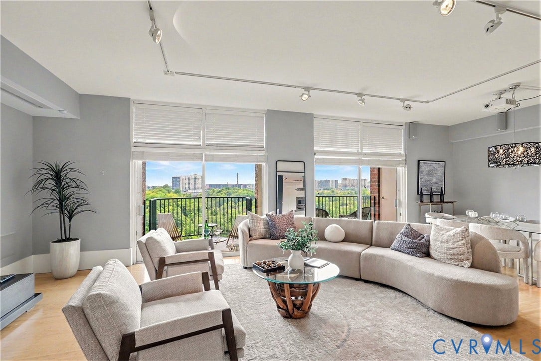 1101 Haxall Point, #U512 U510, Richmond, VA 23219 Hardwood-style flooring, expansive sliding glass doors, balcony access, track lighting, and a modern chandelier