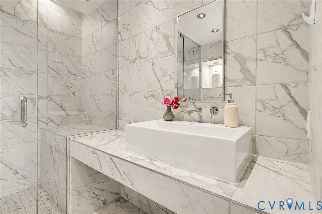 1101 Haxall Point, #U512 U510, Richmond, VA 23219 Marble-effect wall tiling, glass-enclosed shower, built-in shower bench, rectangular vessel sink, and wall-mounted faucet