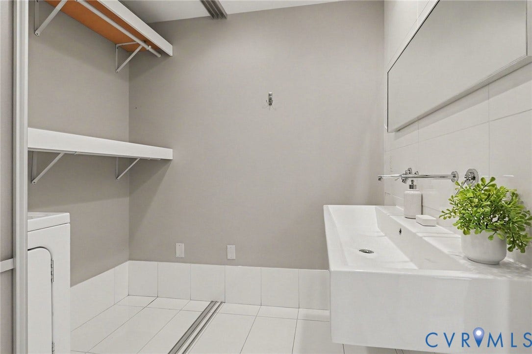 1101 Haxall Point, #U512 U510, Richmond, VA 23219 Floating vanity with integrated basin, wall-mounted faucet, and rectangular mirror