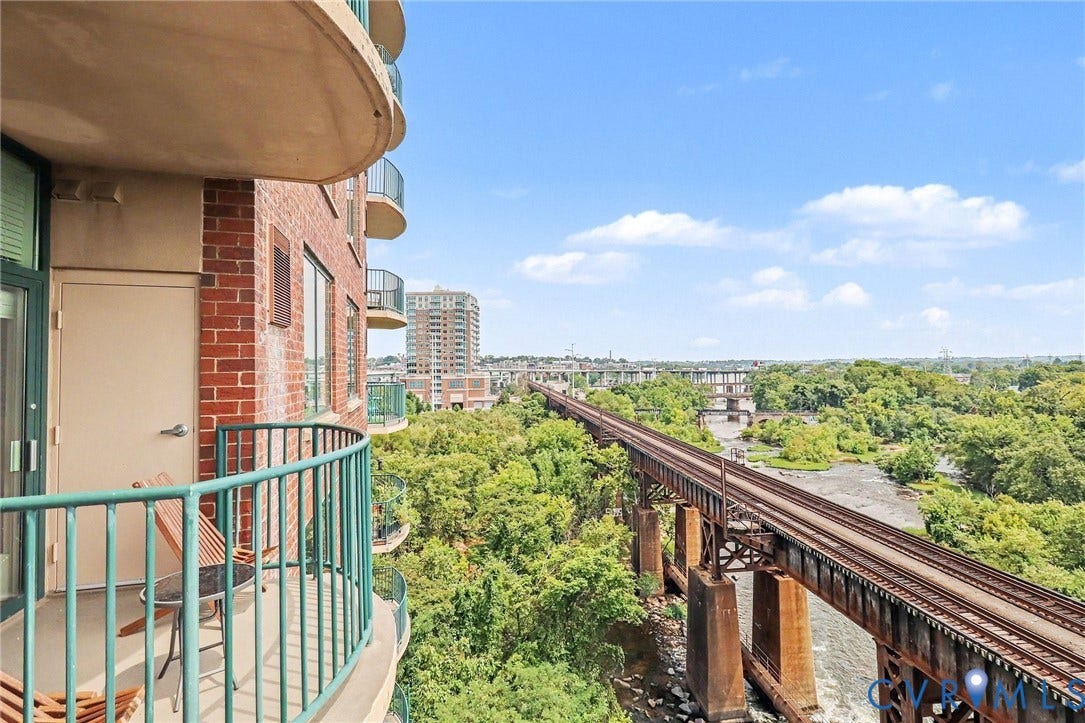 1101 Haxall Point, #U512 U510, Richmond, VA 23219 Private curved balcony with green metal railing, brick exterior, and expansive natural scenery
