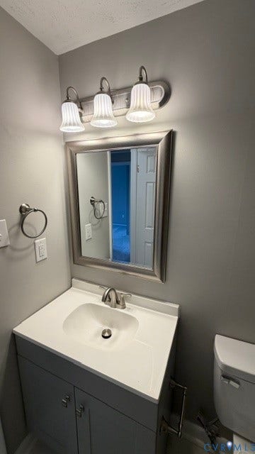 Vanity with an integrated white sink, brushed nickel faucet, and a framed mirror