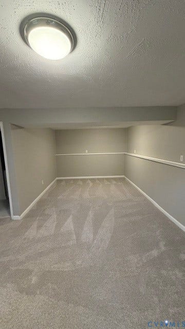 Recessed ceiling light fixture illuminating a spacious room with light gray carpet and white wall trim