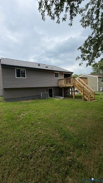 Expansive backyard with a new wood deck, newly installed siding, and a new roof