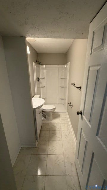 Tile flooring, vanity with integrated sink, and a shower/tub combination