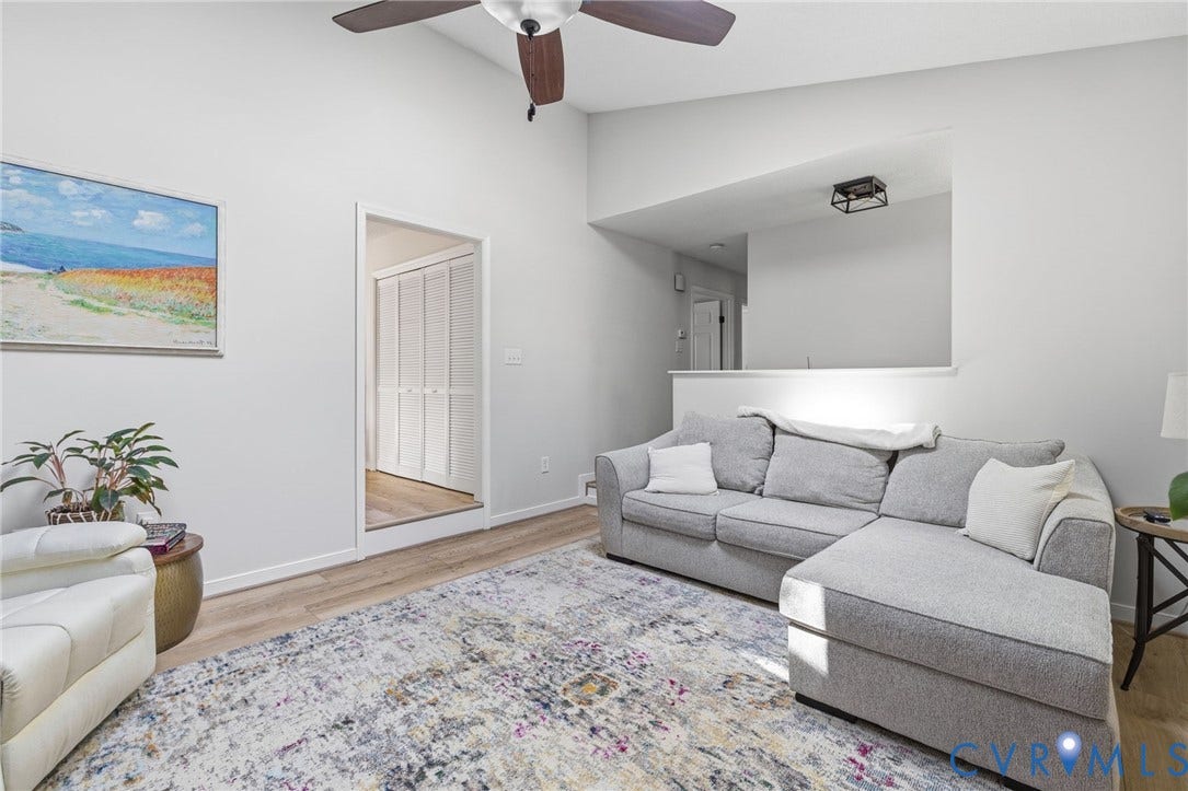 10744 Brookley Road, Glen Allen, VA 23060 Vaulted ceiling, wood-finish flooring, ceiling fan, open doorway, and a half-wall partition