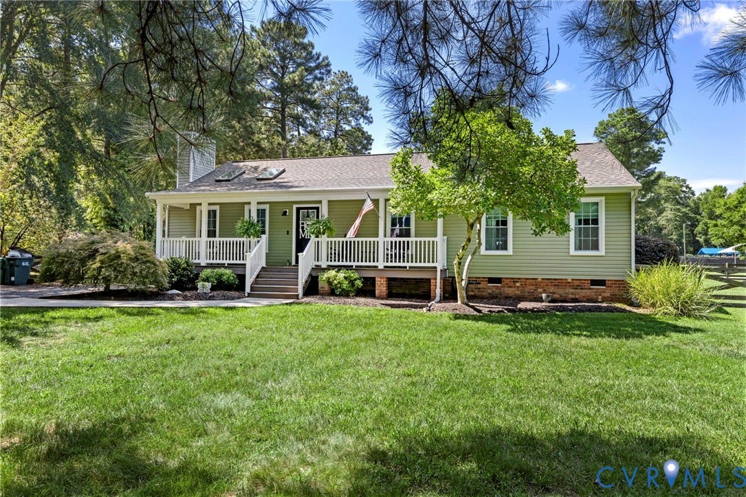 10744 Brookley Road, Glen Allen, VA 23060 Ranch-style residence featuring light green siding, a covered front porch with white railings, and a prominent chimney