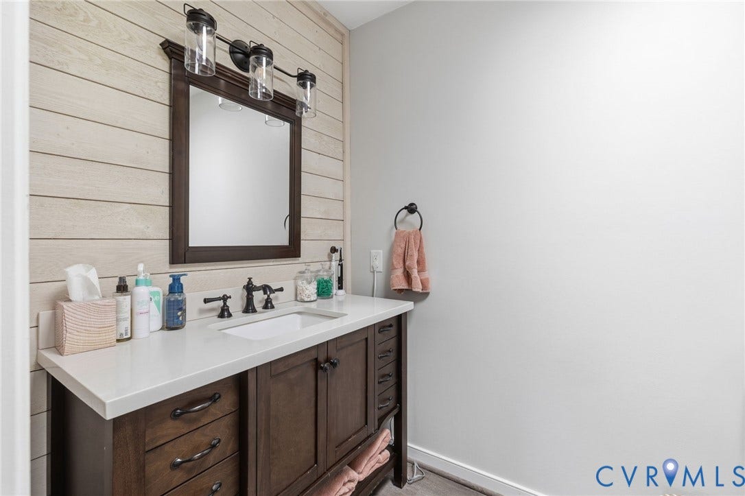 10744 Brookley Road, Glen Allen, VA 23060 Hardwood vanity with shaker-style cabinetry, white countertop, and dark-finish hardware