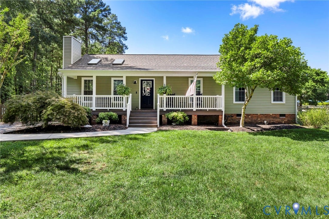 10744 Brookley Road, Glen Allen, VA 23060 Ranch-style residence featuring light green siding, a covered front porch with white railing, a dark entry door, and a shingled roof with skylights