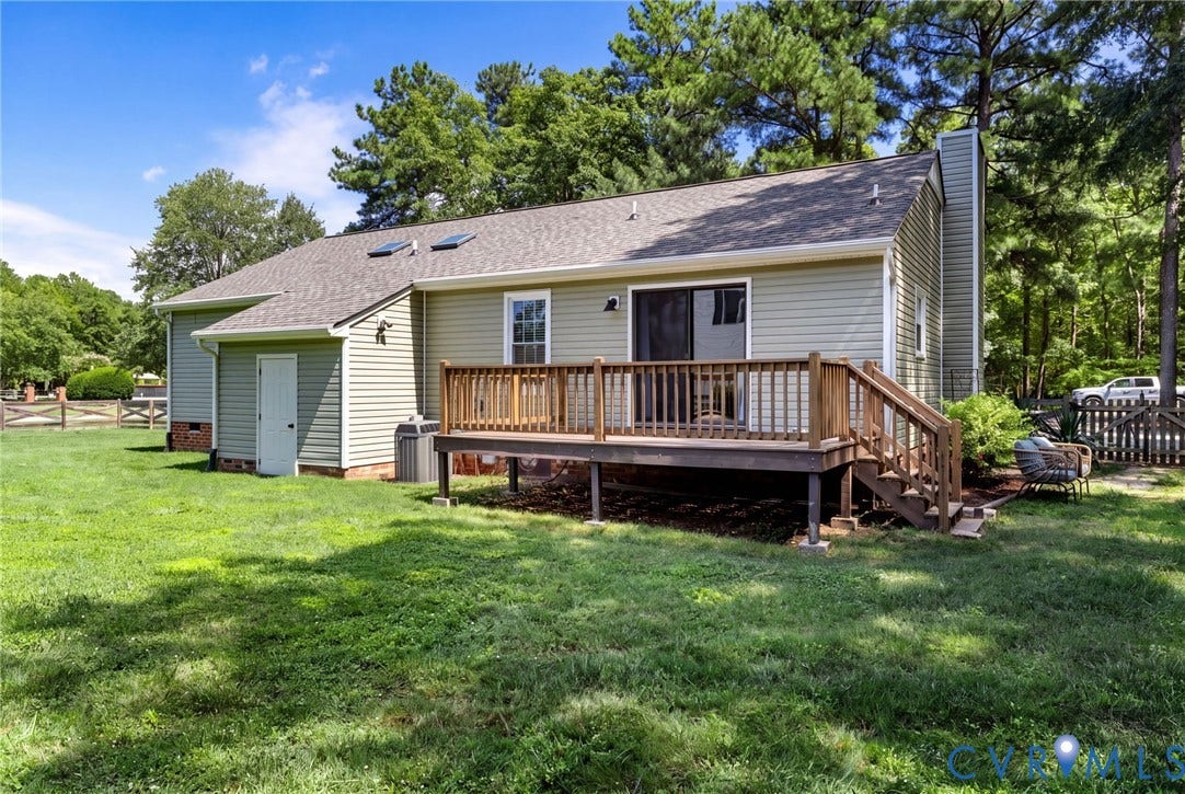 10744 Brookley Road, Glen Allen, VA 23060 Rear exterior featuring a wooden deck with railing, light-colored siding, and a sliding glass door