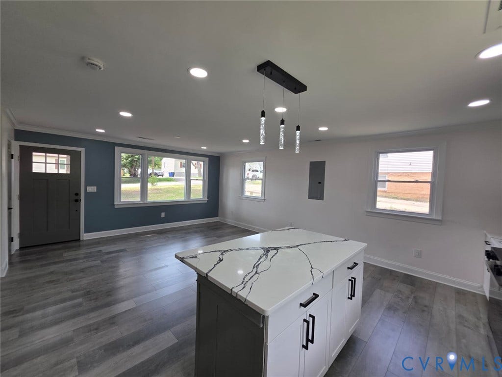 16109 Meridian Avenue, Chester, VA 23831 Kitchen island with a waterfall-edge countertop, grey wood-finish flooring, recessed lighting, and a modern linear pendant light fixture