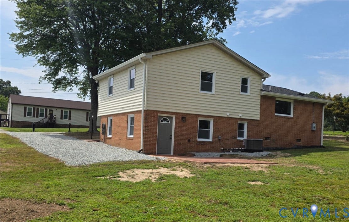 16109 Meridian Avenue, Chester, VA 23831 Two-story structure with brick and siding exterior, gravel driveway, and a red paver patio