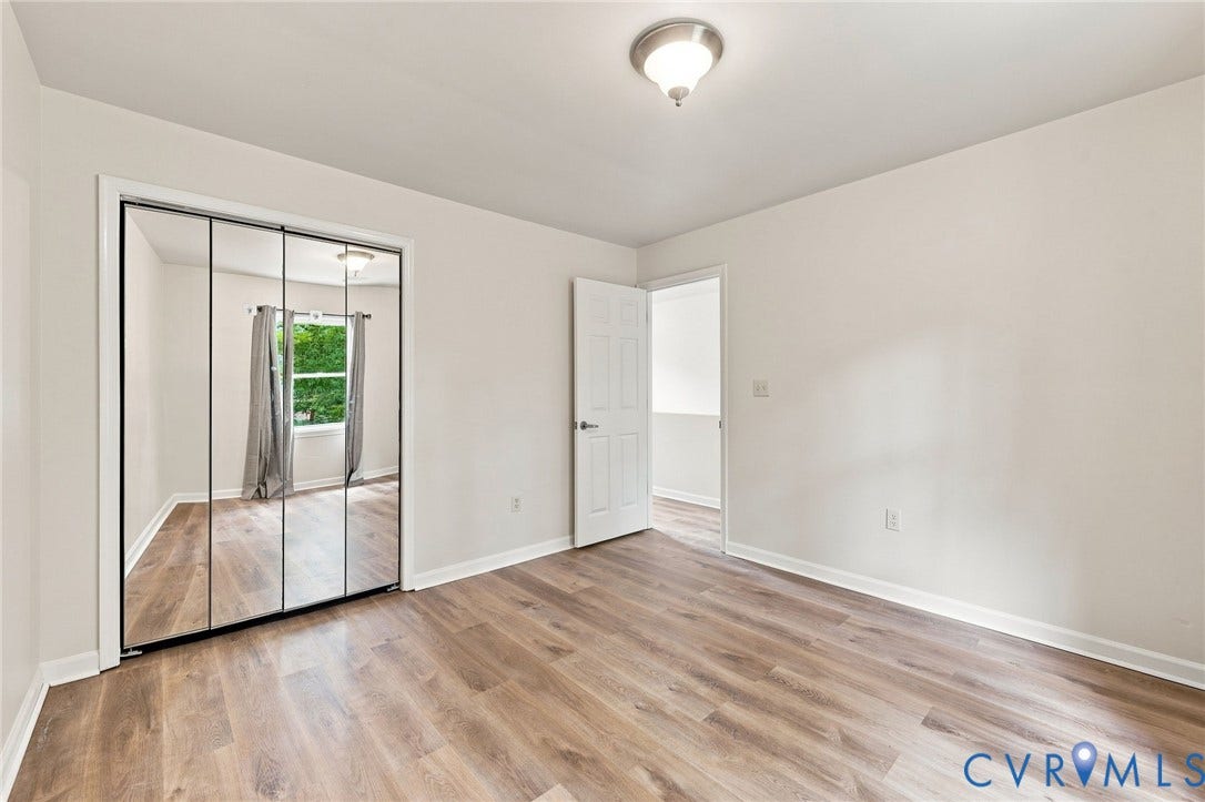 2807 Executive Drive, John Tyler Woods, Chesterfield, VA 23831 Wood-finish flooring, mirrored closet doors, flush-mount ceiling light, white painted walls, and white trim