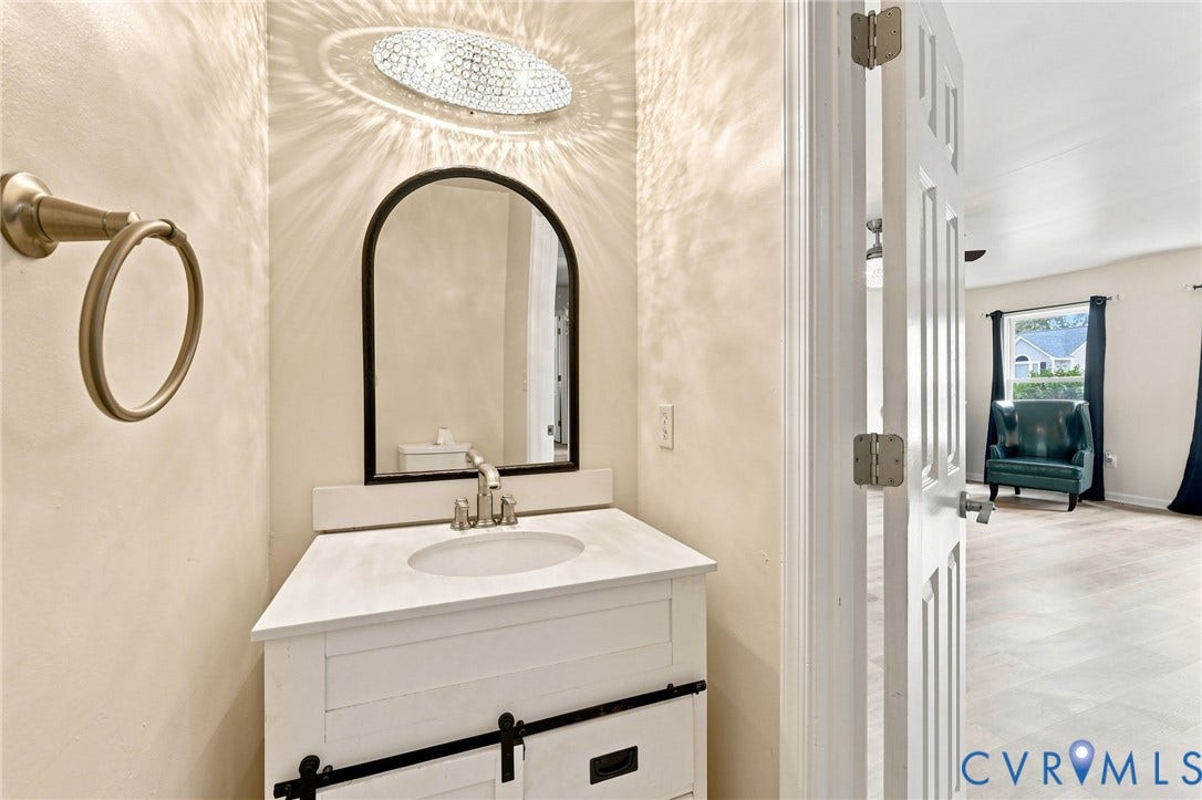 2807 Executive Drive, John Tyler Woods, Chesterfield, VA 23831 White vanity with black hardware, integrated sink, and an arched mirror