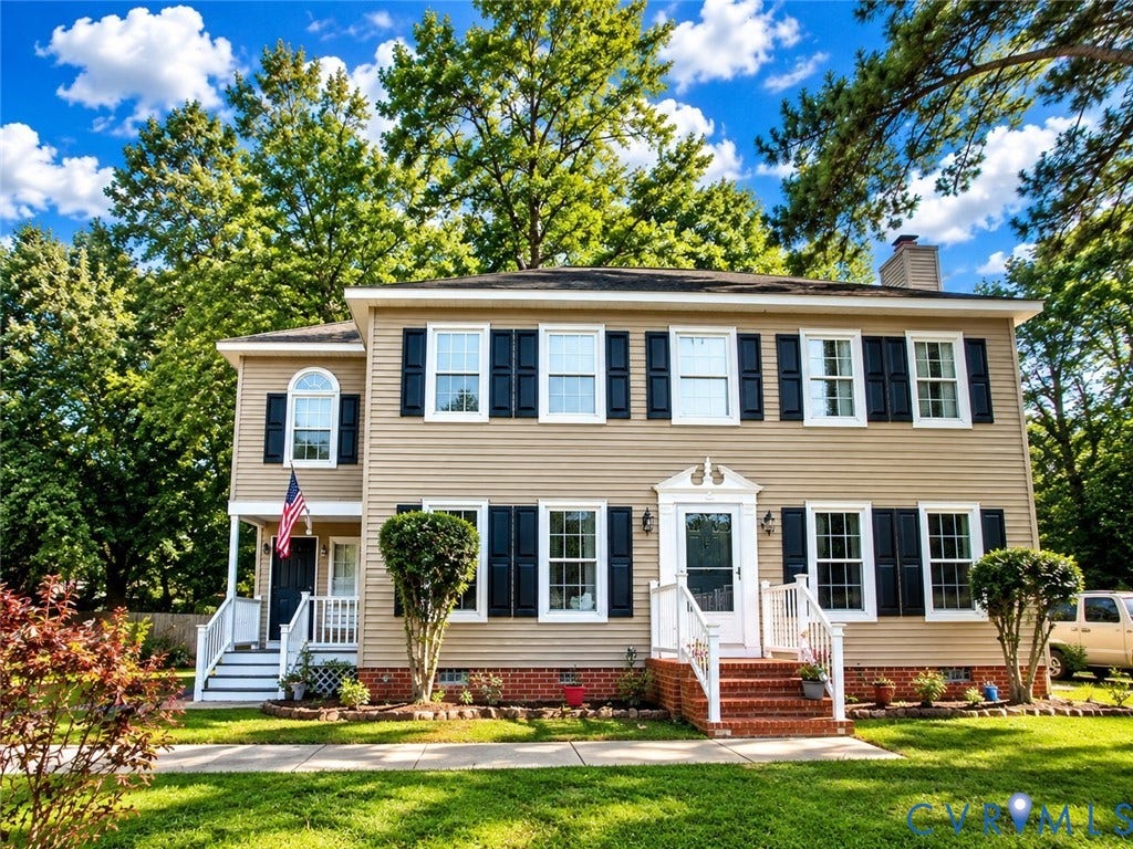 2807 Executive Drive, John Tyler Woods, Chesterfield, VA 23831 Two-story residence featuring light-colored siding, dark shutters, and a prominent front entrance with a white door and railing